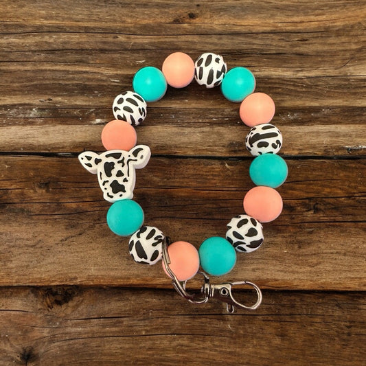Aqua and Peach wristlet with Black Cow Print